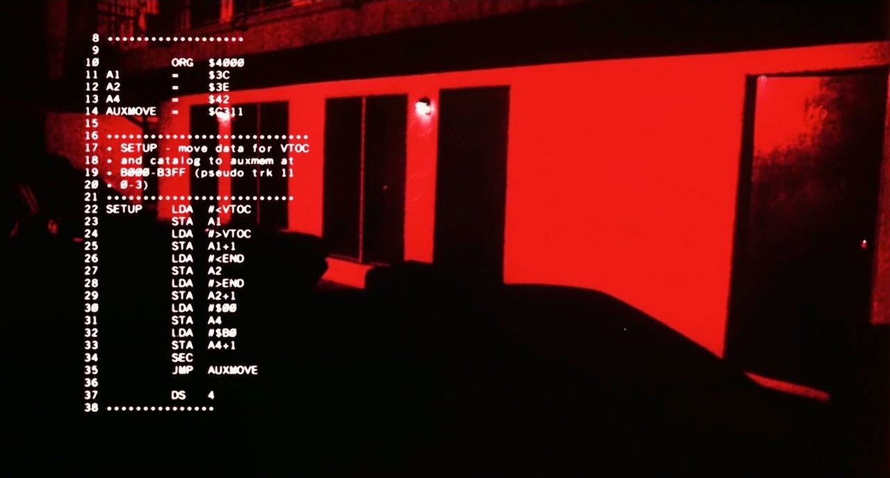 Another HUD frame, later in the film, with the same code visible — reproduced for critical commentary